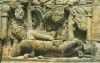 Borobudur. Figure resting in a garden. Possibly the future Buddha in the park at Kapilavastu palace.